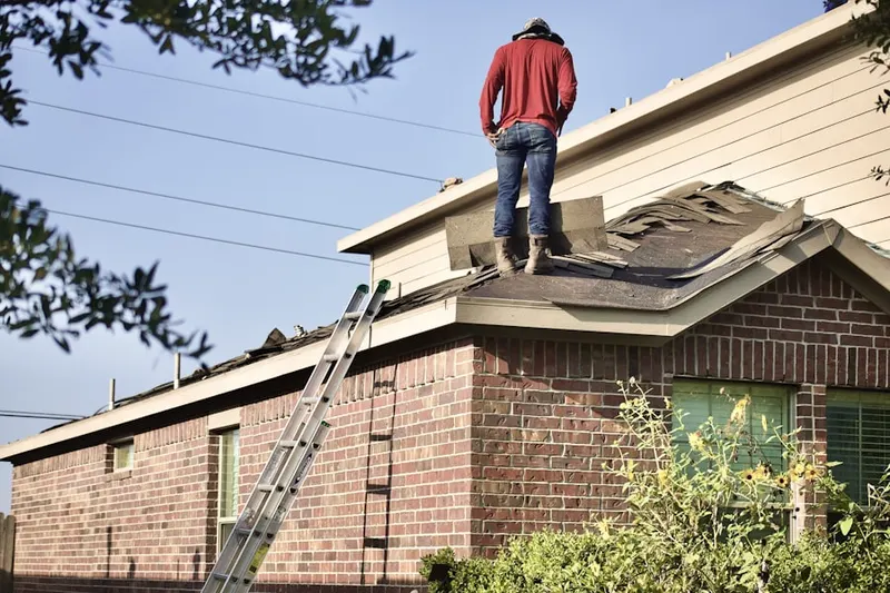 Professional roofer working on a residential roof in Covered Bridge